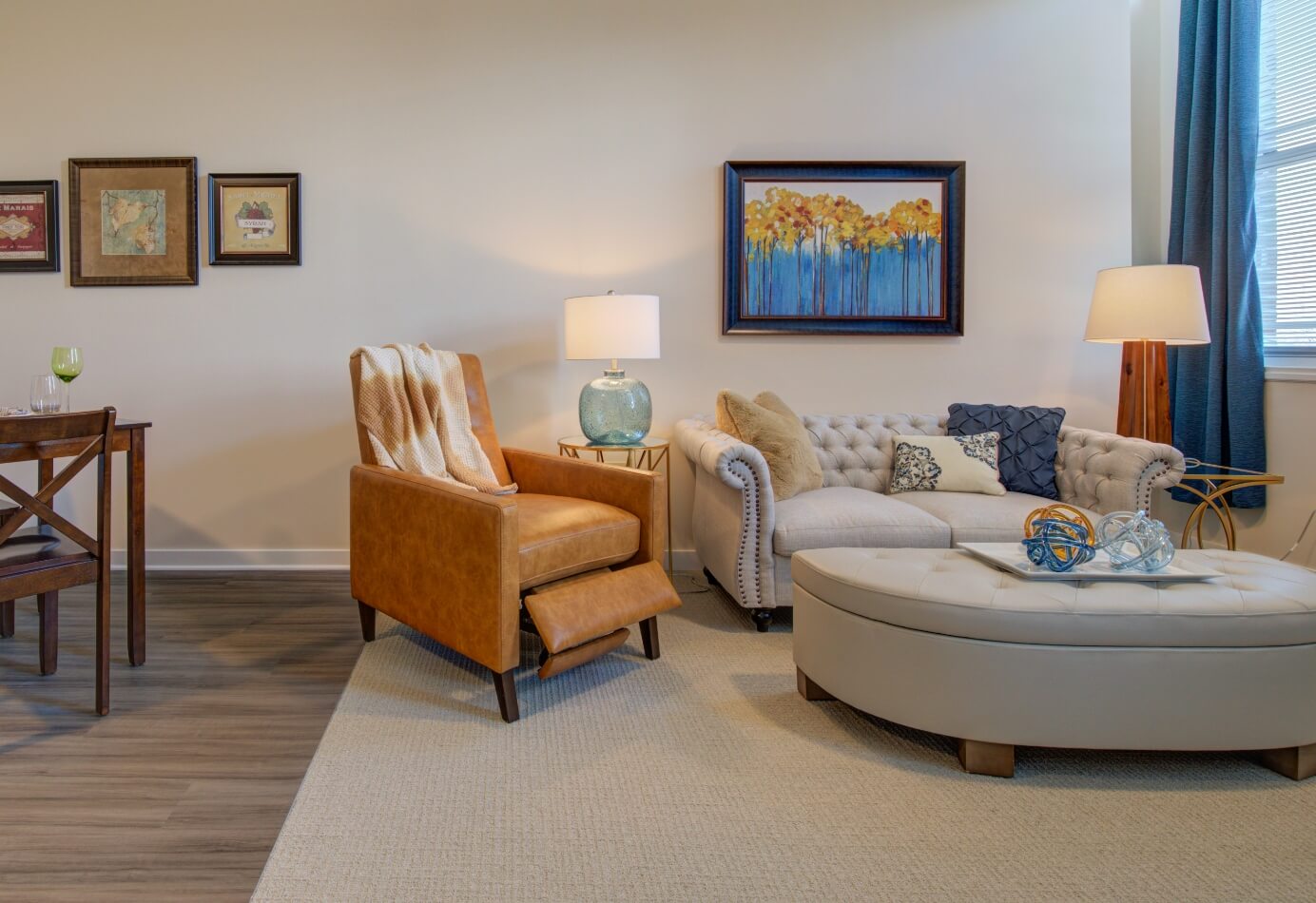 Comfortable senior living apartment with leather recliner, sofa, and warm lighting at Amazing Grace Senior Living