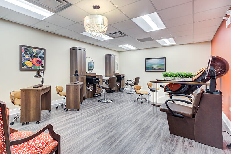 Modern beauty and barber salon with styling stations and spa chairs at Amazing Grace Senior Living