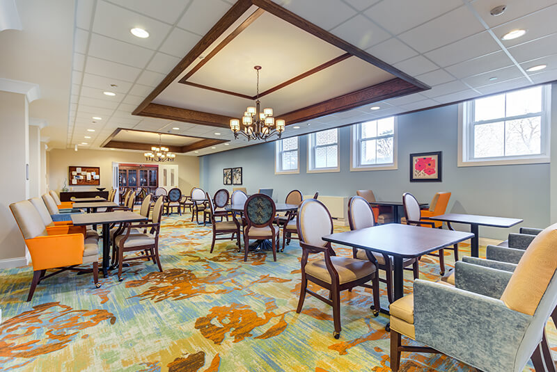 Welcoming dining area with patterned carpet and modern decor at Amazing Grace Senior Living