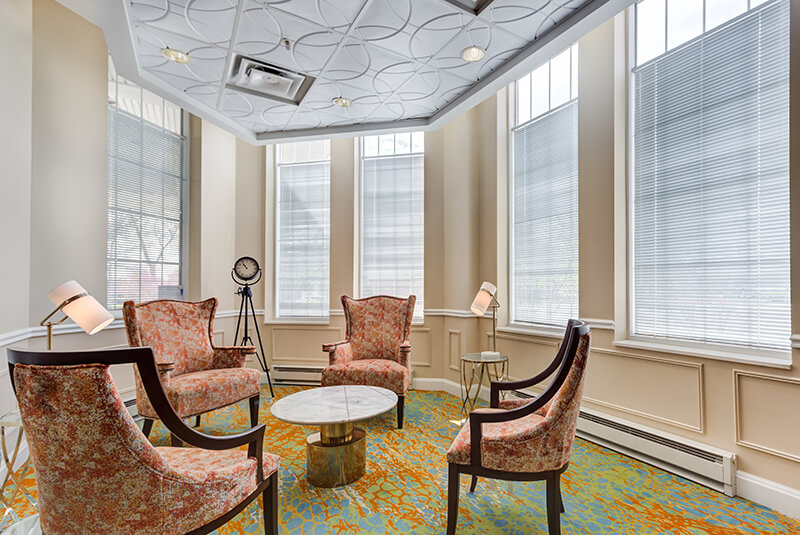 Inviting lobby with plush seating, accent lighting, and modern finishes at Amazing Grace Senior Living