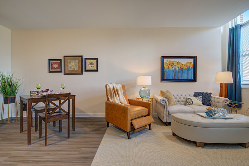 Open-concept dining and living room area in a one-bedroom apartment at Amazing Grace Senior Living
