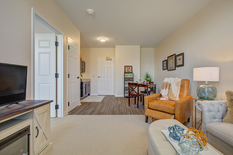 Entryway of one-bedroom apartment showing kitchen and dining space at Amazing Grace Senior Living