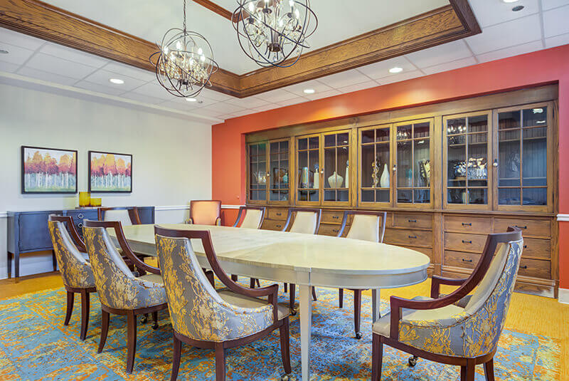 Elegant private dining room with decorative lighting and seating for special gatherings at Amazing Grace Senior Living