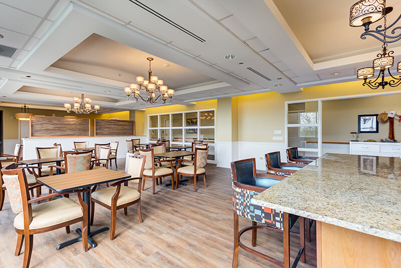 Bright residential lounge with large windows and comfortable seating at Amazing Grace Senior Living