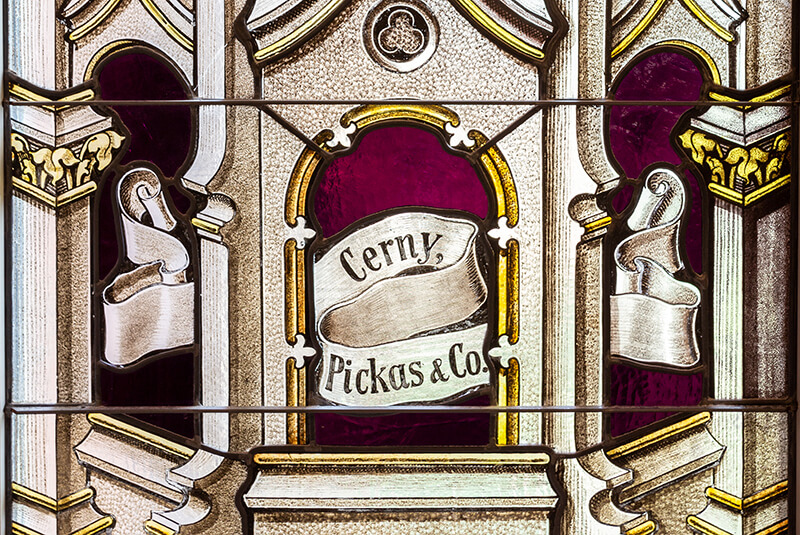 Stained-glass window featuring the inscription “Cerny, Pickas & Co.” at Amazing Grace Senior Living
