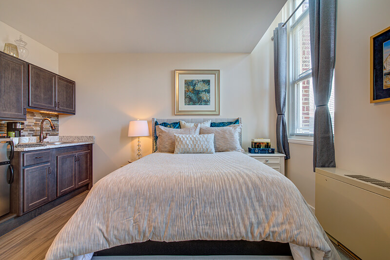 Comfortable bedroom area with natural light and soft tones at Amazing Grace Senior Living