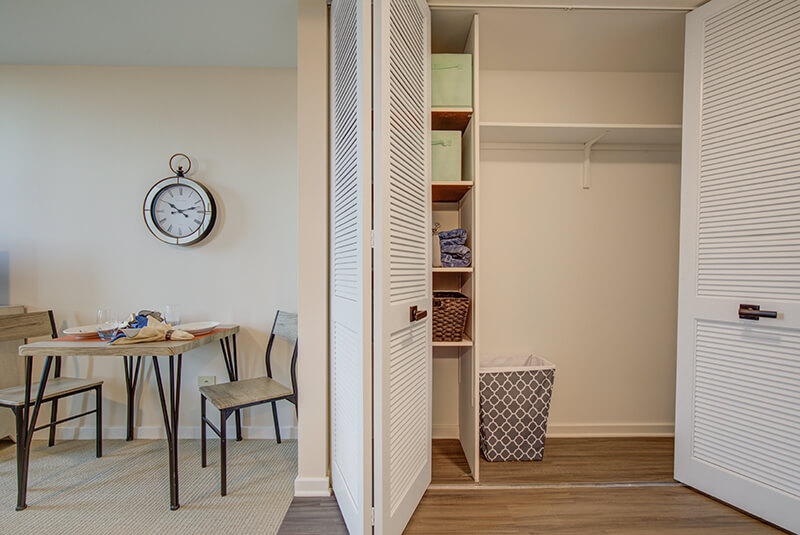 Spacious studio apartment closet with built-in shelving and storage at Amazing Grace Senior Living