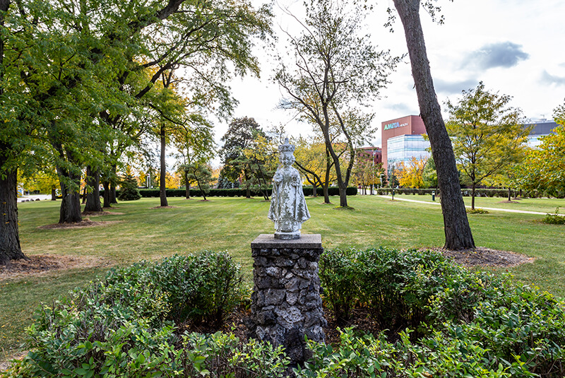 Tree-lined path with seasonal foliage at Amazing Grace Senior Living